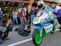 SPAIN VALENCIA MOTORCYCLE GRAND PRIX LUETHI Followed by photographers and cameramen and pushed by his mechanic Stefan Fuhrer, right, Swiss motorcycle pilot Thomas Luethi on his Honda, starts onto the Circuito Ricardo Tormo during the second free practice, in Cheste, Spain, Saturday, November 5, 2005. Luethi will race the 125cc class of Sunday's Motorcycle Grand Prix of Valencia, lacking a mere 3 points to win the world championship. (KEYSTONE/Photopress/Alessandro della Valle)